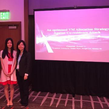 Two people in front of a screen displaying ANT+ Symposia 2014.