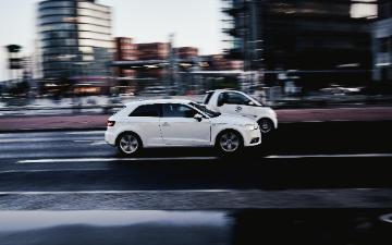 Cars speeding down a city road 