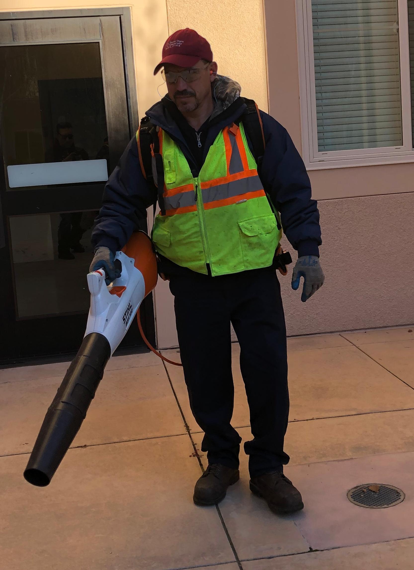 SCU gardener using electric leaf blower