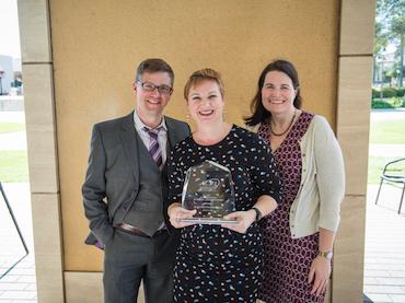 University Librarian Jennifer Nutefall holding award with Associate University Librarians Rice Majors and Elizabeth McKeigue