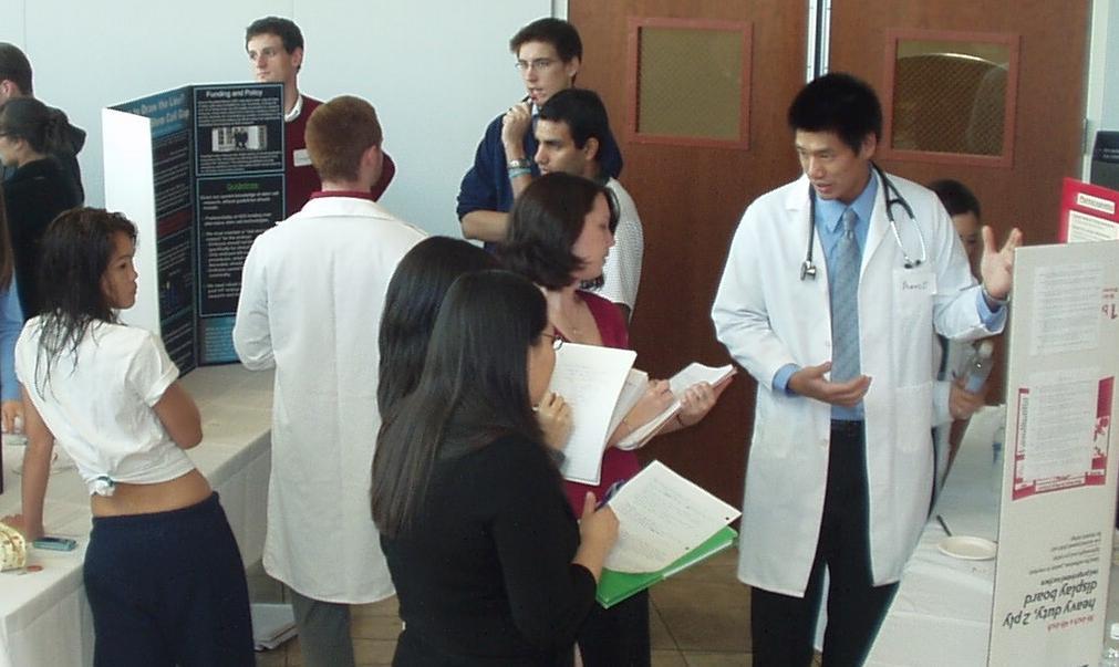 Students describe their bioethics projects at a poster session.