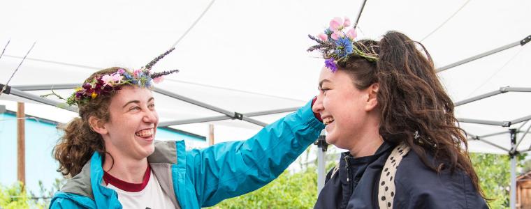 SCU students smile and model flower crowns at the Forge